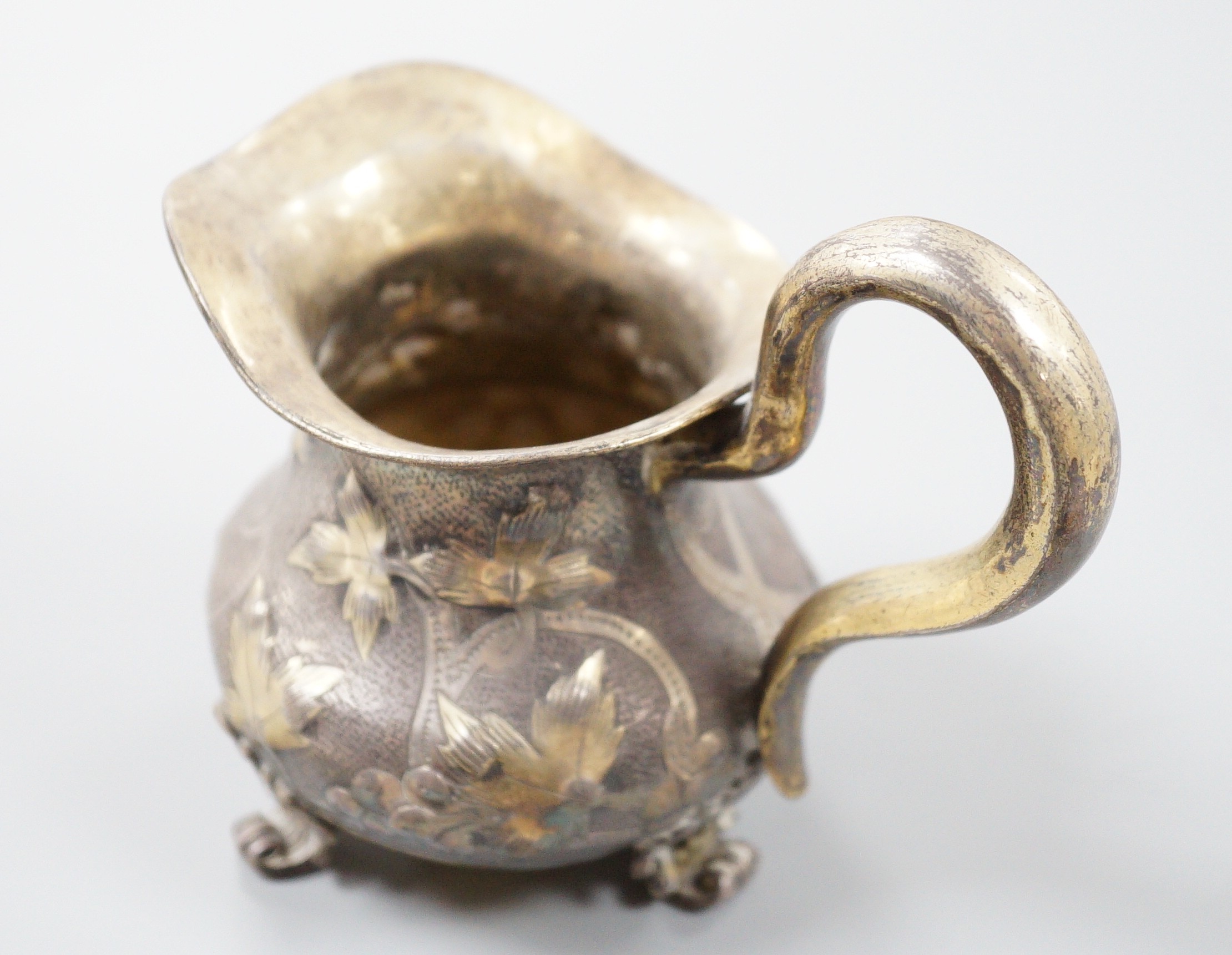 A 19th century Russian gilt white metal cream jug, indistinct marks, 94mm, 109 grams.